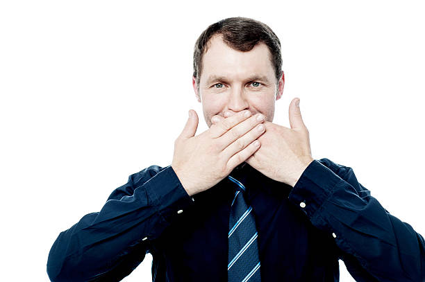 istock Businessman covering his mouth with hands 504129551