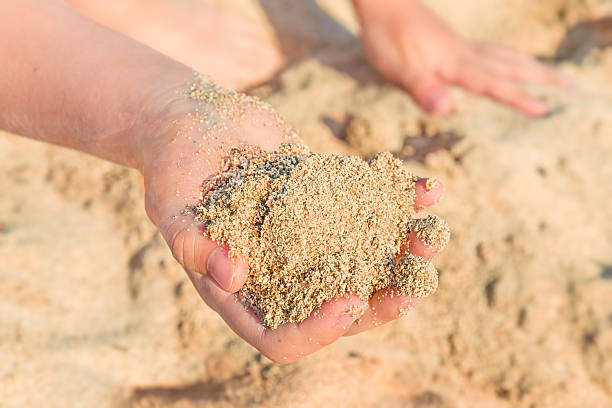 istock Child’s hand palm with sea sand closeup 504130031