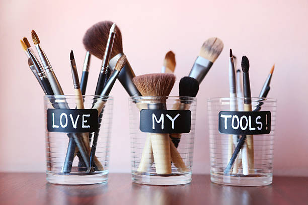 Makeup brushes Make up brushes in glass jars - love my tools mascara wands stock pictures, royalty-free photos & images