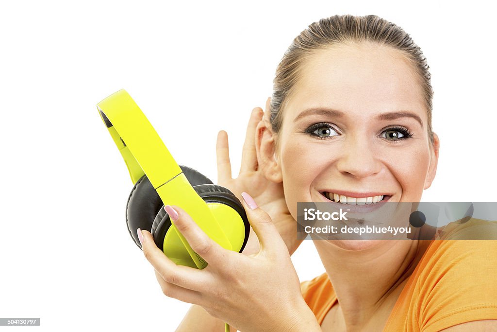 Pretty young woman listen music with headphone headshot Close up of a Pretty young woman in orange t-shirt music with headphone on white Adult Stock Photo