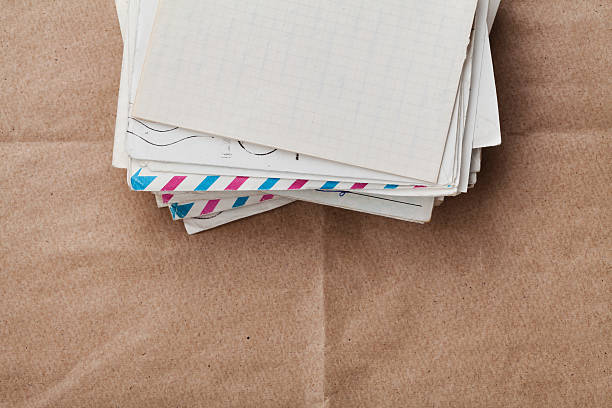 istock Envelopes and letters on kraft paper, top view, cope space 504132340
