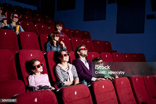 Parents With Children Watching A Comedy Stock Photo - Download Image Now - Adult, Beautiful People, Beauty