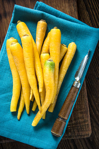 istock Yellow carrots on blue cloth 504133474