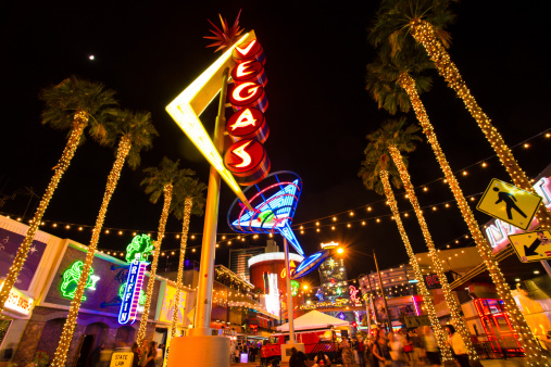 Las Vegas, Nevada, USA - May 7, 2014: :  View of Fremont Street with vintage lit Vegas sign in Las Vegas Nevada with visitors visible.  Fremont Street in downtown Vegas is a pedestrian mall and attraction in the old section of Las Vegas.