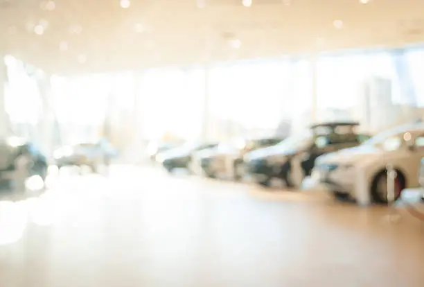 Photo of blurred  new cars dealership place