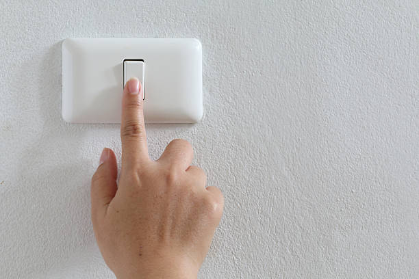 istock closeup finger press turn on/off electric-switch 504134439