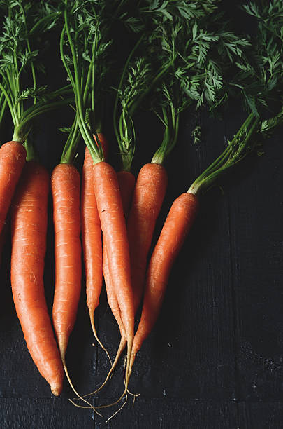 istock Bunch of fresh carrots with green leaves 504134564