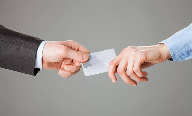 istock Business people passing a plastic card each other 504135064