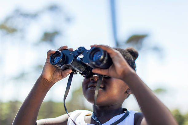 istock African girl looking though a binoculars 504135747