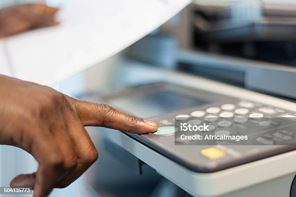 African Businessman Pressing The Start Button To Print Stock Photo - Download Image Now