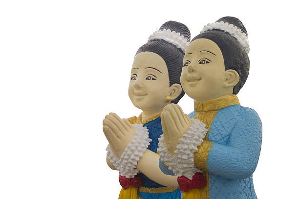 Thai couple curved dolls welcome  in Thai traditional greeting on white background.