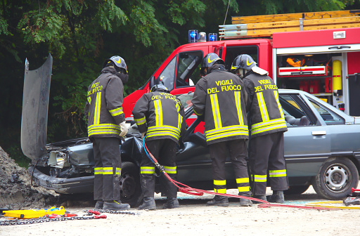 Val Della Torre, Italy - September, 28 2014: Simulation of road accidents, joint intervention between firefighters and rescuers (Red Cross).  Demonstration held in September 2014  in the province of Turin in Piedmont (Italy)