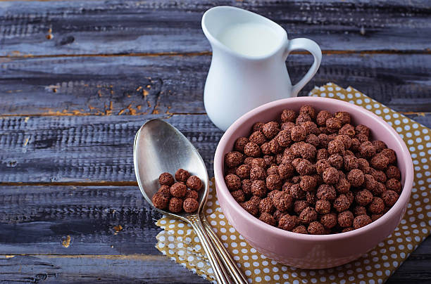 istock Chocolate cereal balls in bowl and milk 504178760