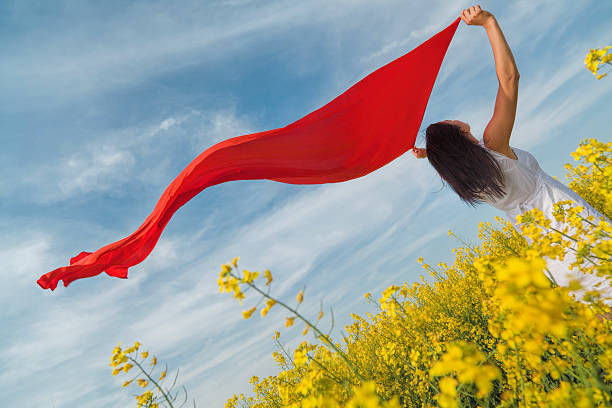 istock Young woman in rape holding red scarf to wind 504180810