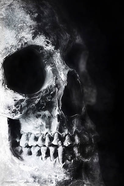 istock Digital art, paint effect, cracked and damaged human skull 504183456