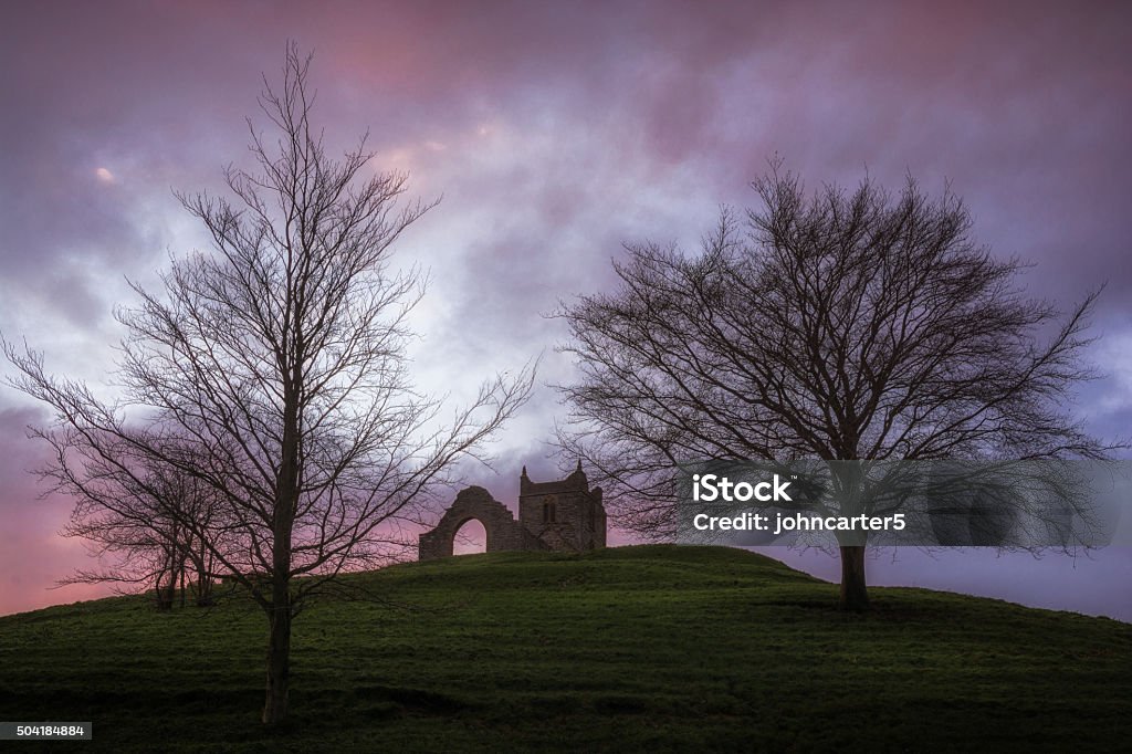 Burrow Mump Church Ruins Burrow Mump is a hill and historic site overlooking Southlake Moor in the village of Burrowbridge within the English county of Somerset. It is a scheduled monument, with the ruined church on top of the hill a Grade II listed building. Somerset - England Stock Photo