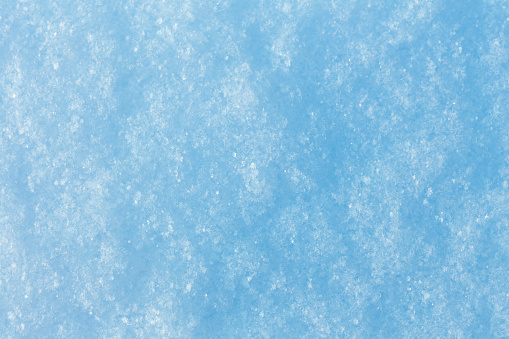 The texture of the snow surface closeup. The softness, purity, winter concept.