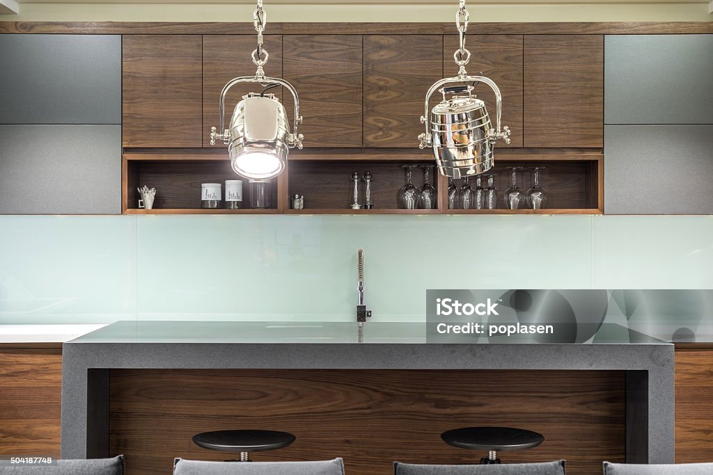House bar with stools House bar with stools and two silver reflector as chandelier Apartment Stock Photo