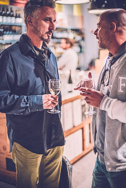 istock Two Men Talking to Each Other in a Wine Bar 504190078