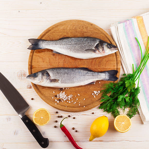 istock Two fresh sea bass on a white background. Top view. 504190958