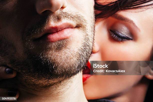 Woman Kissing A Man On The Neck Stock Photo - Download Image Now - Kissing, Men, Women