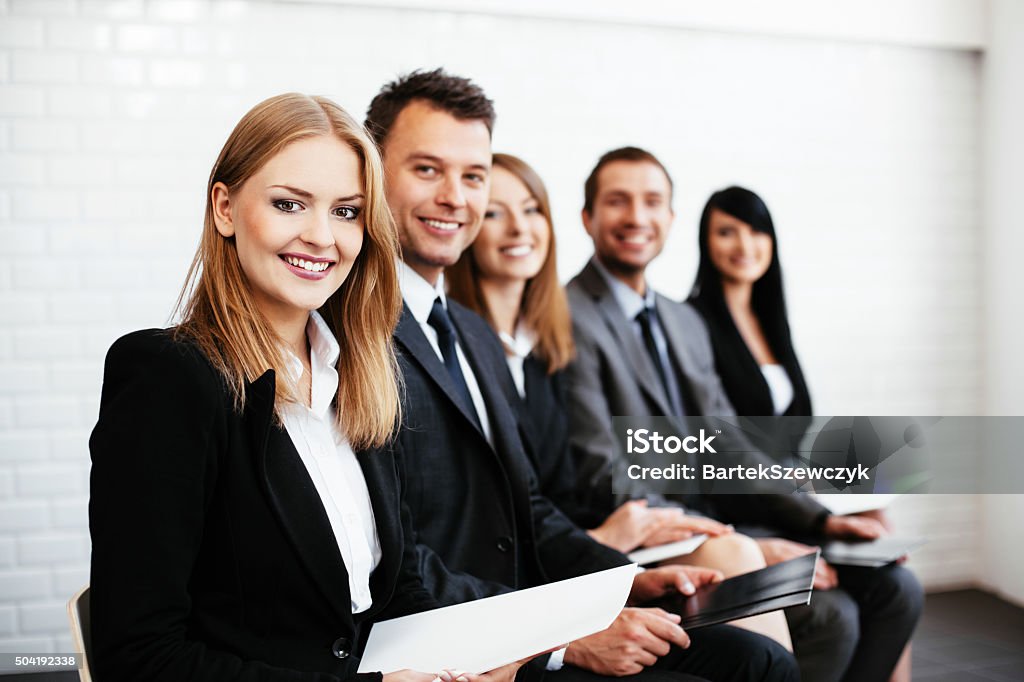 Group of happy business people sitting in a row Recruitment Stock Photo