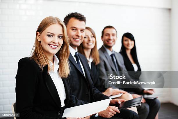 Group Of Happy Business People Sitting In A Row Stock Photo - Download Image Now - Recruitment, Job Interview, Human Resources