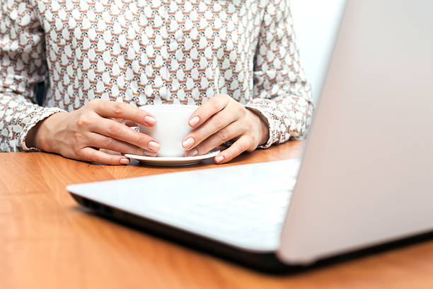 istock Woman using laptop with a cup of coffee. 504192634