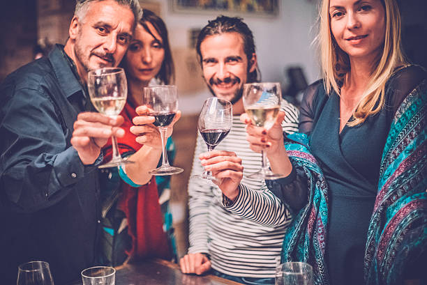 istock Group of Friends Toasting with Wine, Looking At Camera 504194008