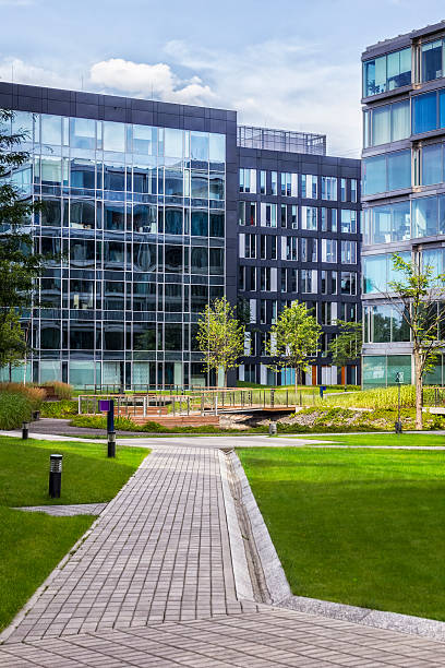 istock Green square with chairs in front of office buildings 504219484