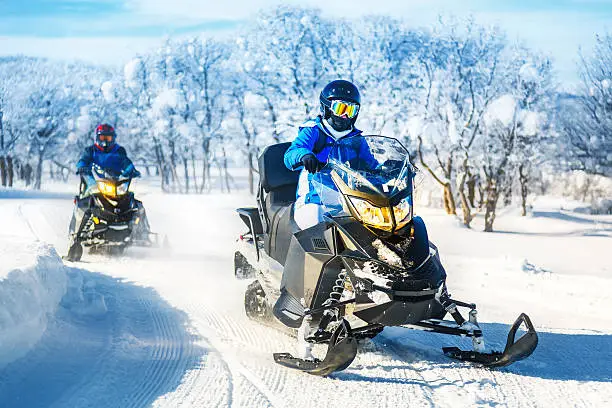 Driving snowmobiles in Colorado, USA - panning motion blur