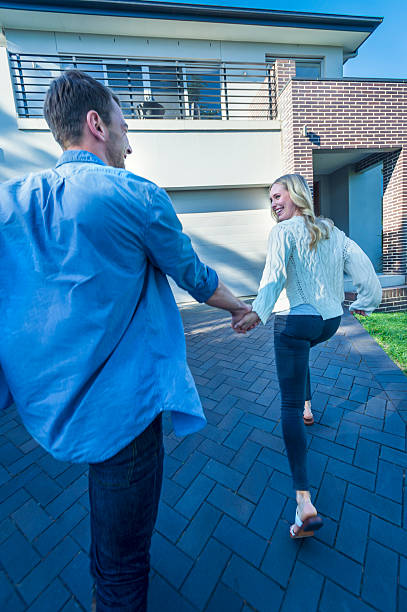 istock Couple joyfully running into their new home. 504223130
