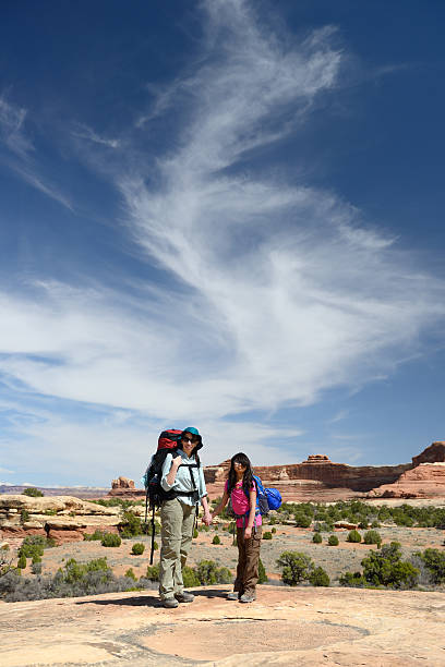 istock Mother and Daughter Backpacking Under Beautiful Sky 504223600