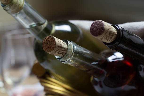 istock Red ,white and rose wine bottles in wicker  basket 504224032