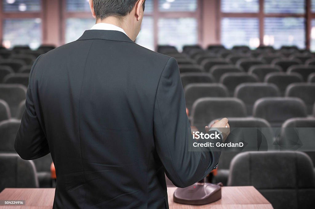Businessman practising his speech in emtry conference room Audience Stock Photo