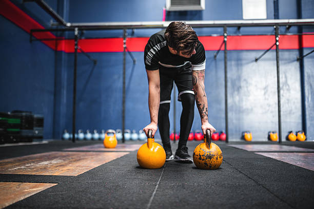 istock man keeping the balance on the kettlebells 504227416