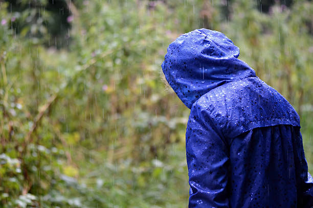 istock Child in a blue waterproof coat in the rain 504227440