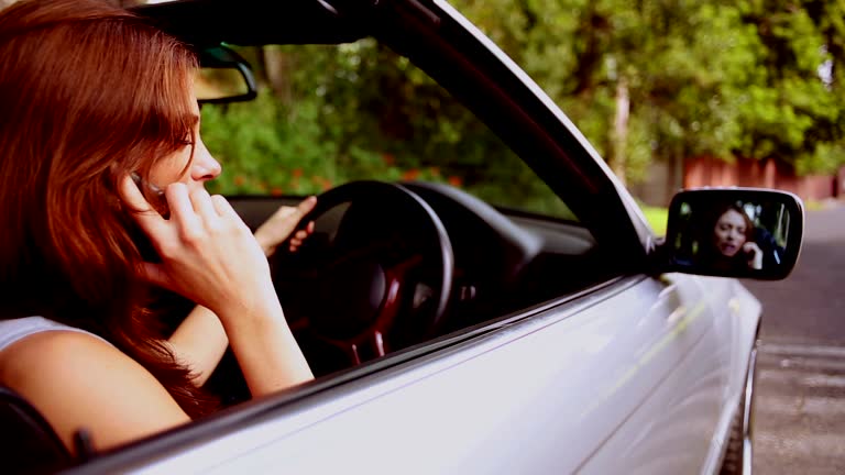 Woman in a silver car