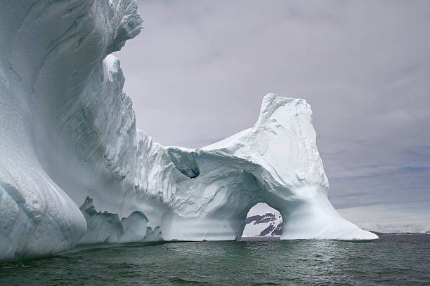 istock large iceberg with a through arch in Antarctic waters 504237793