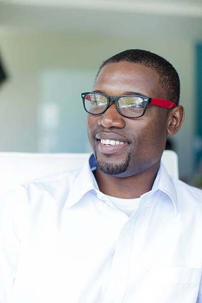istock African businessman smiling while sitting at the boardroom table 504238793