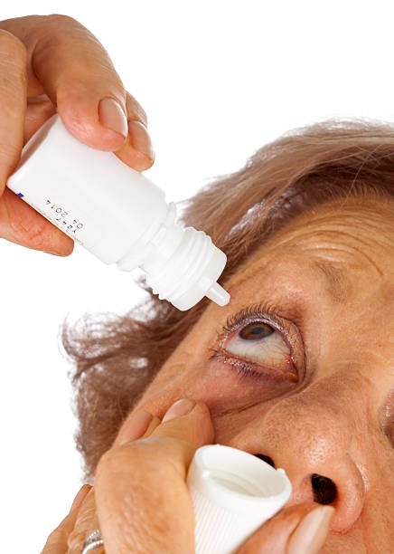 istock Elderly woman applying eye drops 504239365