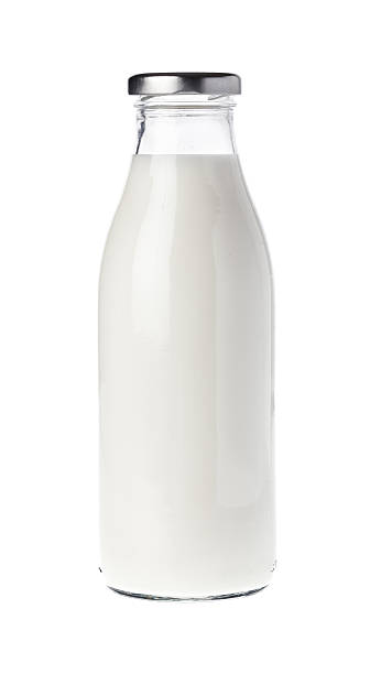 Filled milk bottle Filled glass bottle with milk isolated on white. milk bottle stock pictures, royalty-free photos & images