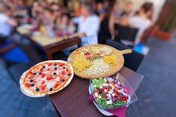 Tourists having food on a street restaurant Rome Italy stock photo