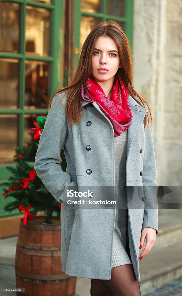 Attractive fashion girl in coat on the city street Attractive fashion girl in a coat on the city street Adult Stock Photo