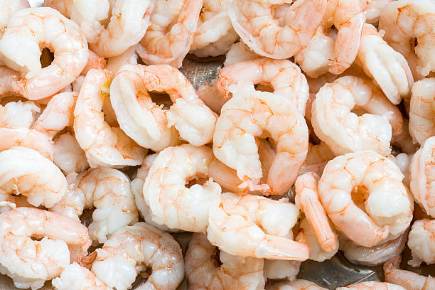 istock Raw Peeled shrimps background 504243492