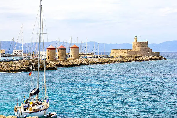 Rhodes landmark - Mandraki Port, the medieval lighthouse, windmills
