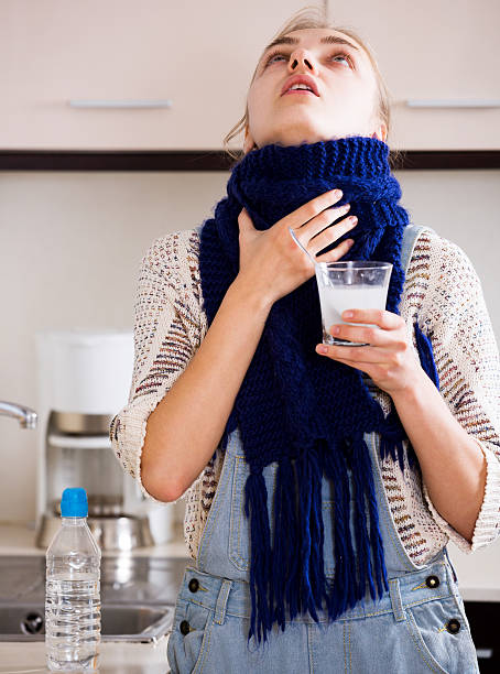 istock Girl with quinsy taking medicine 504245134