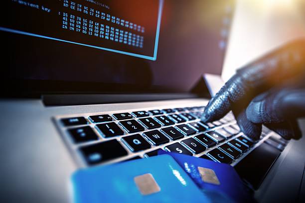 Unauthorized Payments Credit Cards Theft Concept. Hacker with Credit Cards on His Laptop Using Them For Unauthorized Shopping. Unauthorized Payments identity theft photos stock pictures, royalty-free photos & images
