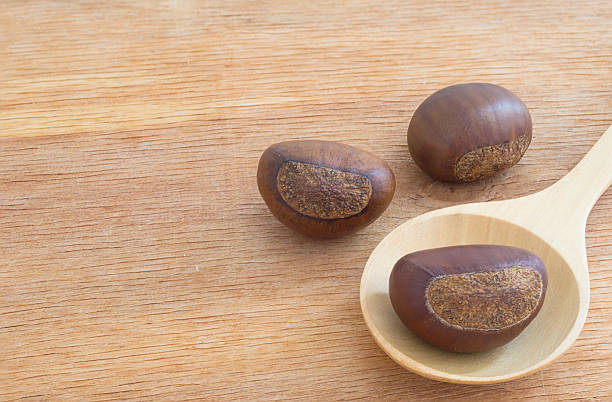 istock chestnut  in a wooden spoon 504250300