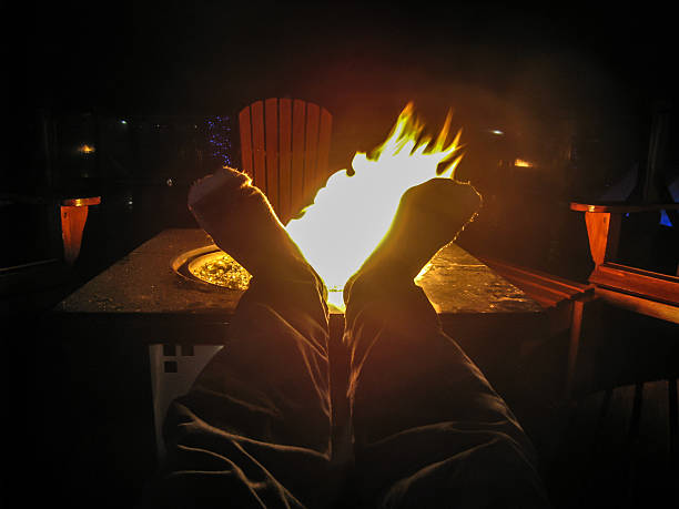 burning wood in a fire bowl against a black background